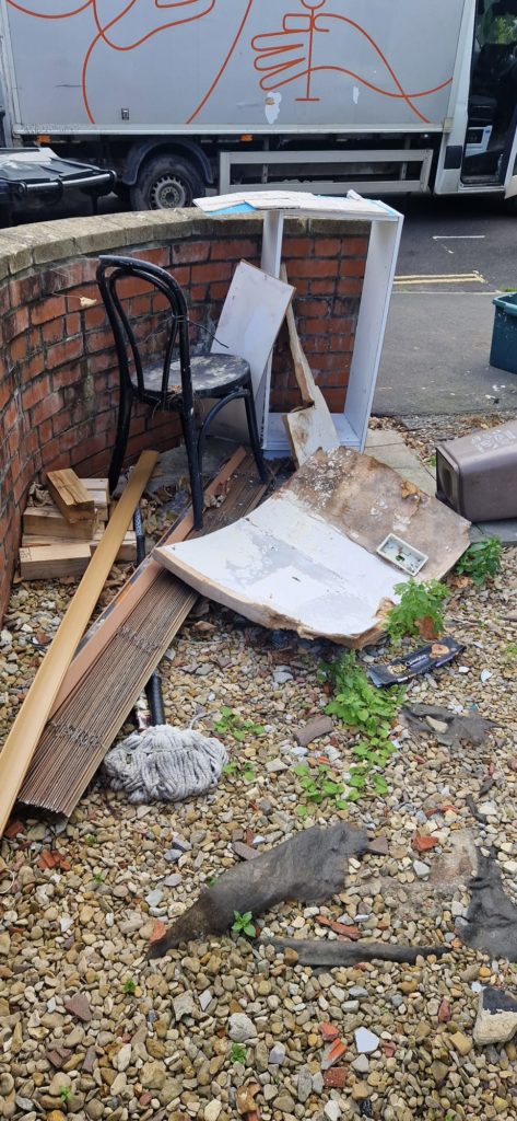 Professional team carrying sofas during house clearance